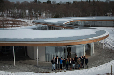 far shot of a student group standing in front of an architecturally interesting building