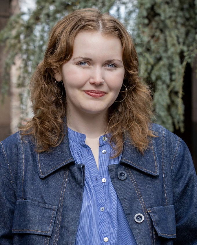 Ella head shot, with red hair and denim jacket