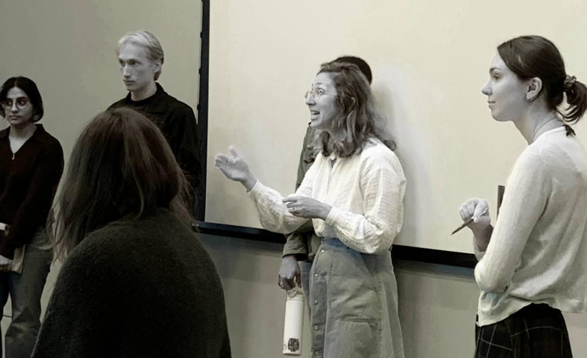 Holly shaffer standing and speaking with students