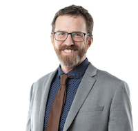 David with suit and glasses