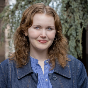ella headshot with red hair and denim jacket